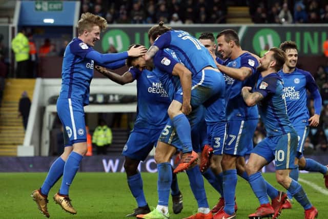 Posh players celebrate Ryan Tafazolli's goal at Aston Villa. Photo: Joe Dent/theposh.com.