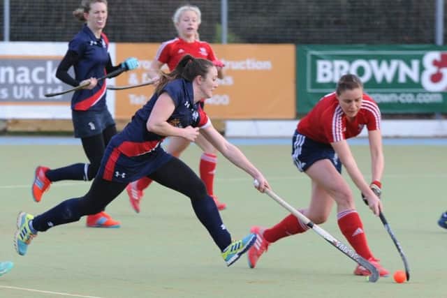 Verity Allen (red) defends as City of Peterborough Ladies beat Cambridge City seconds 2-0 at Bretton Gate. Photo: David Lowndes.