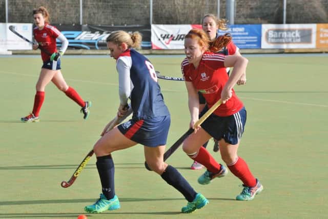 Player-of-the-match Kate Dixon (red) in action for City of Peterborough Ladies during a 2-0 win over Cambridge City 2nds. Photo: David Lowndes.
