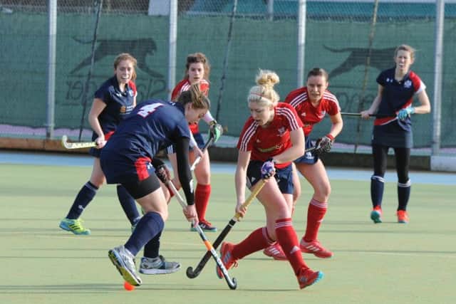 Anna Faux (red) in action form City of Peterborough Ladies against Cambridge City . Photo: David Lowndes.