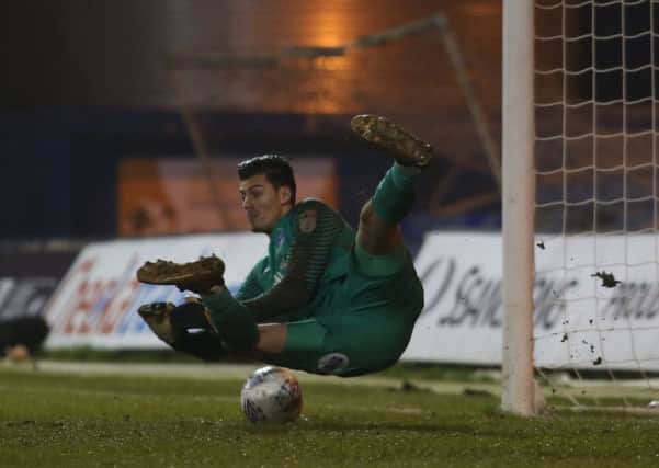 Posh goalkeeper Jonathan Bond makes a match-clinching penalty save at Luton. Photo: Joe Dent/theposh.com.