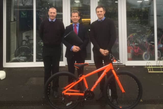 New move: from left, Paul Bonham of Terry Wright Cycles, Alex Spires of Barclays and Ben Fletcher, employee of Terry Wright Cycles.