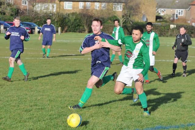 Action from Eye United's Intermediate Shield win at FC Peterborough (green). Photo: David Lowndes.