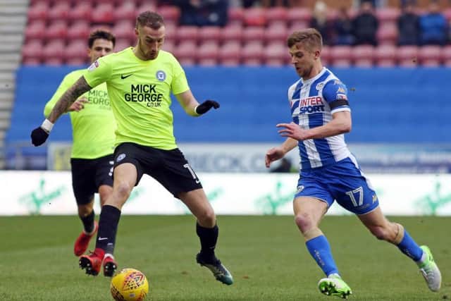 Posh attacker Marcus Maddison in action with Michael Jacobs of Wigan. Joe Dent/theposh.com