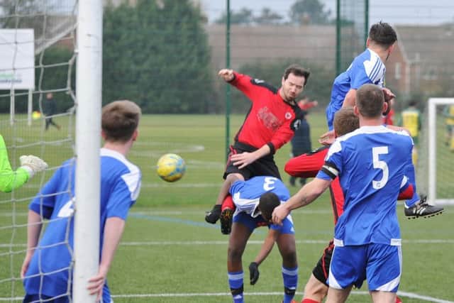 Action from Netherton's 1-0 win over Peterborough Sports Reserves (blue). Photo: David Lowndes.