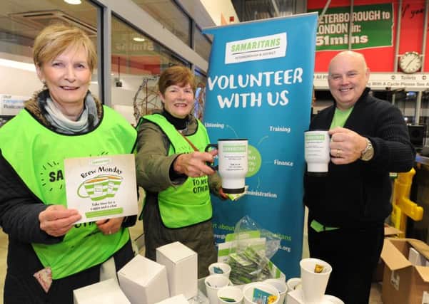 Carol Corosby, a Samaritans director, Sue Horsley, a volunteer. and Allan McGeadie, Samaritans treasurer -  handing out tea and coffee mugs to commuters at Peterborough Railway Station on Brew Monday. EMN-180115-080003009