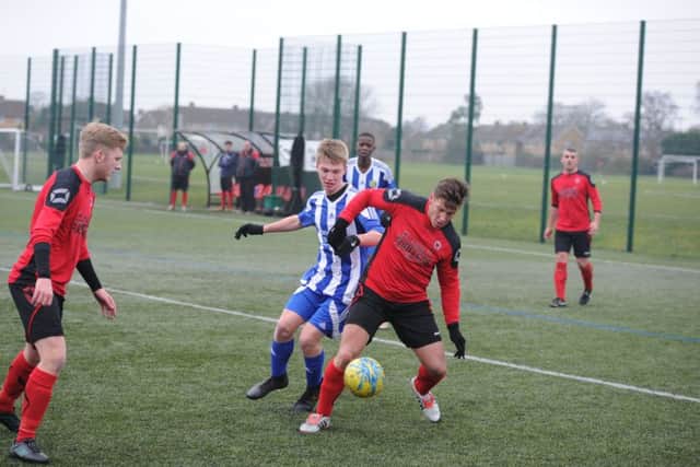 Dan Fountain scored the only goal of the game for Netherton against Peterborough Sports Reserves last weekend. He's seen here (red shirt) in action in that game. Photo: David Lowndes.