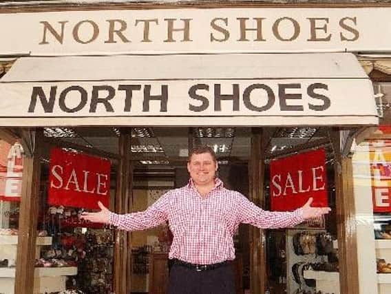 James North outside the North Shoes shop in Bourne.