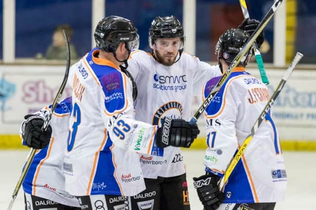 Tom Norton (centre) celebrates scoring against Swindon with team-mates Ales Padelek and James Ferrara.