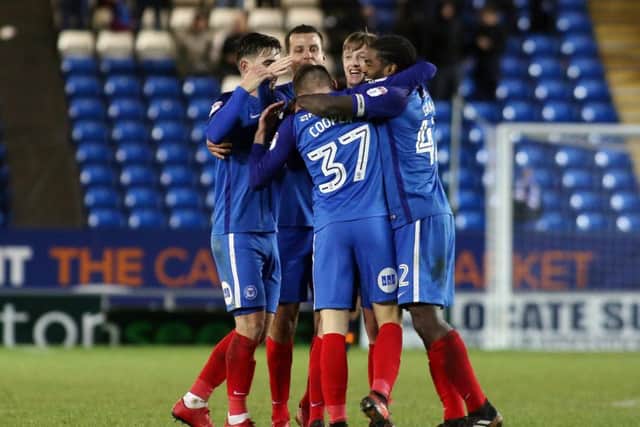 Posh players congratulate George Cooper after his debut goal against Oldham. Photo: Joe Dent/theposh.com.
