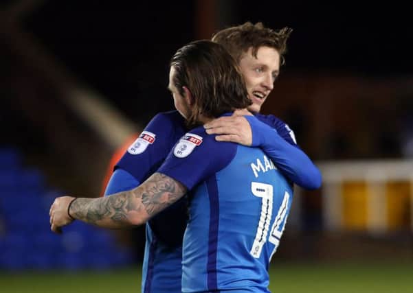 Chris Forrester celebrates with Posh team-mate Jack Marriott after a 3-0 win over Oldham. Photo: JoeDent/theposh.com.