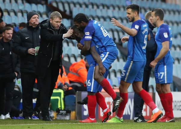 Junior Morias is mobbed by teammates and manager Grant McCann after scoring for Posh v Oldham. Photo: Joe Dent/theposh.com