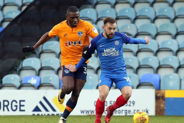 Posh winger Danny Lloyd in action with Temitope Obadeyi of Oldham. Photo: Joe Dent/theposh.com.
