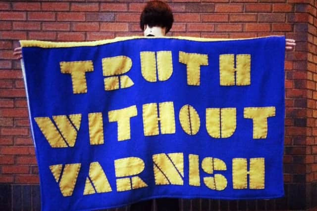 One of the Â hand and machine sewn capes with found sayings  by Kate Genever and Katie Smith