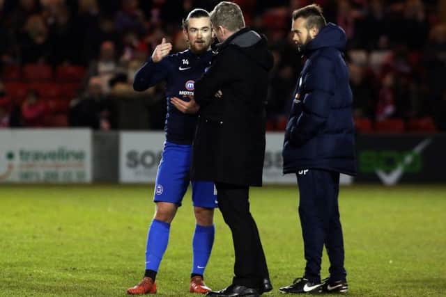 Posh striker Jack Marriott in conversation with manager Grant McCann before the game at Sincil Bank. Photo: Joe Dent/theposh.com.