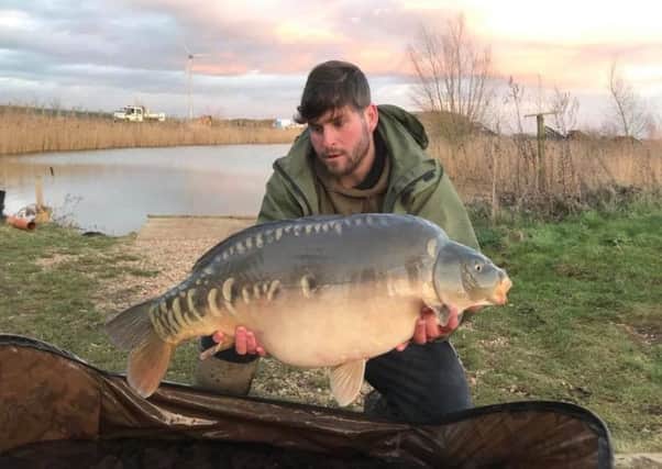 Mike Hudson pictured with one of the 15 huge carp going into Float Fish Farm Fishery as part of their restocking programme.