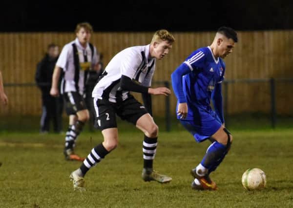 Dan Cotton of Yaxley (blue) holds off Peterborough Northern Star's Stefan Taylor in the Hinchingbrooke Cup quarter-final. Photo: Chantelle McDonald. @cmcdphotos.