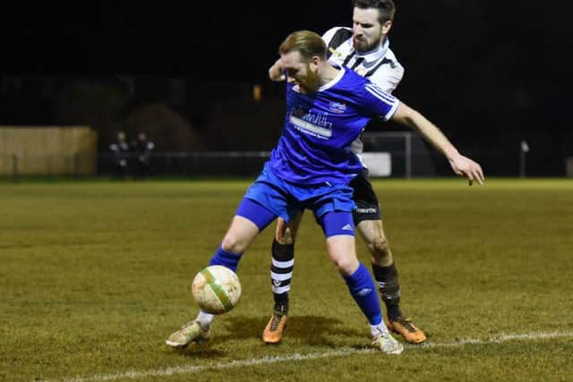 Yaxley's Liam Hook (blue) shields the ball from Peterborough Northern Star's Matthew Barber. Photo: Chantelle McDonald. @cmcdphotos.