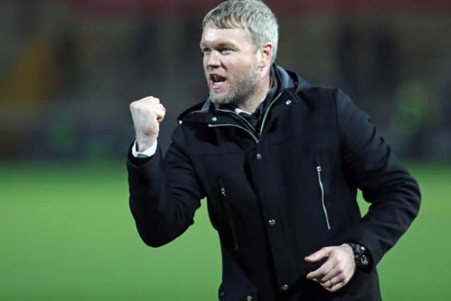Manager Grant McCann celebrates a Posh win.