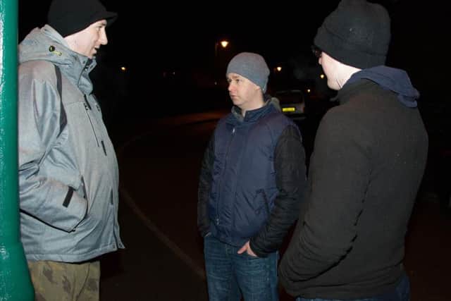 Officers discuss the morning's operation (Centre - DS Graham Clifton) Pic; Terry Harris