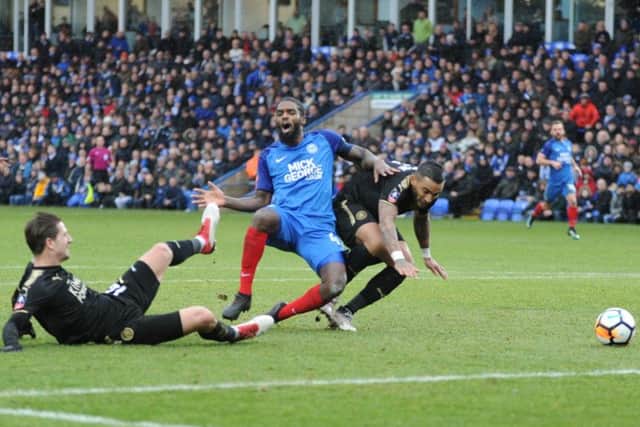 Posh midfielder Anthony Grant goes down under a heavy Leicester challenge. Photo: David Lowndes.
