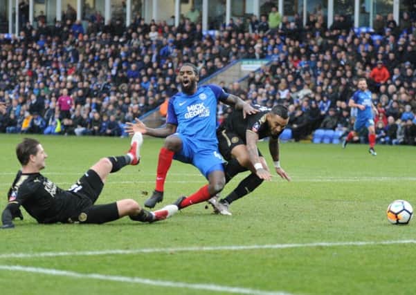 Posh midfielder Anthony Grant goes down under a heavy Leicester challenge. Photo: David Lowndes.
