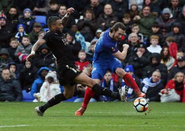 Posh striker Jack Marriott shoots at goal while under pressure from Leicester's Danny Simpson. Photo: Joe Dent/theposh.com.