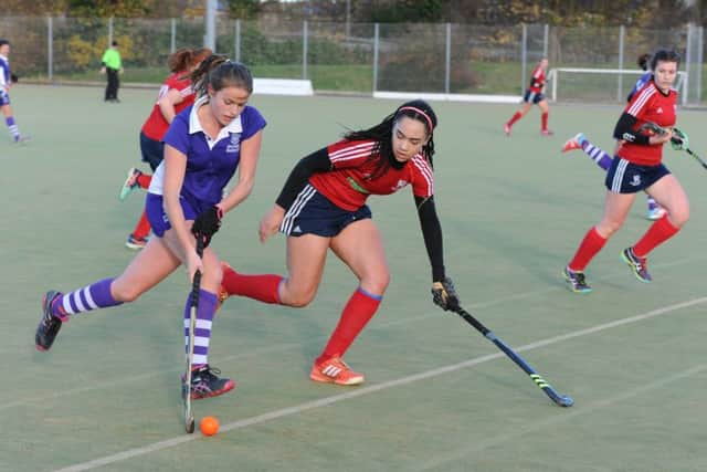 Tierney Augustine (red) scored twice for City of Peterborough Ladies at Cambridge University.