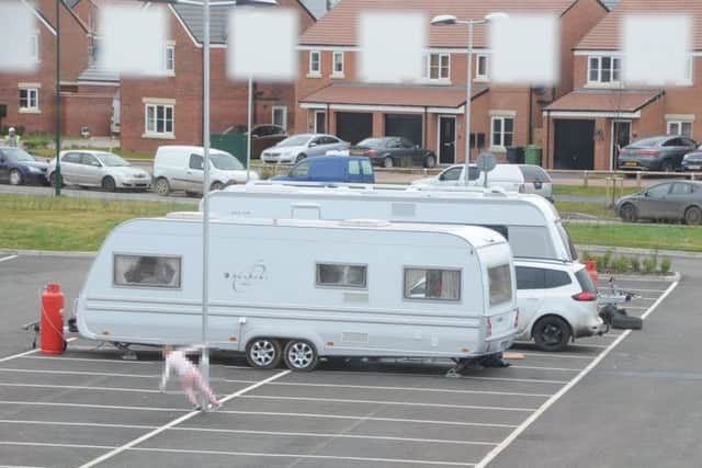 Travellers in the car park at Hampton Garden school EMN-180129-112216009