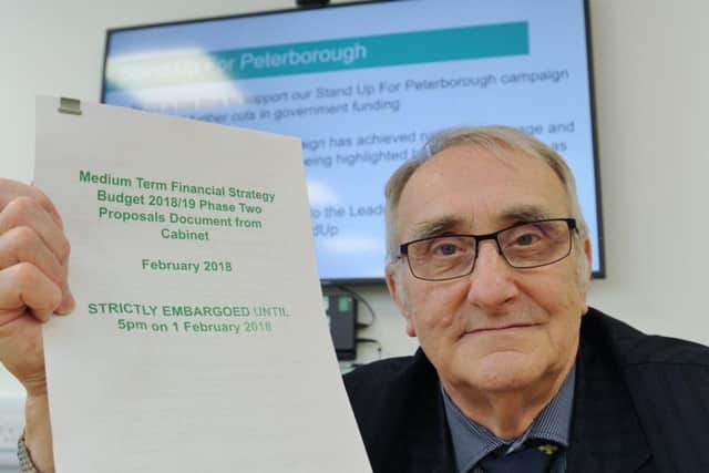 Peterborough City Council leader Cllr John Holdich with a copy of the budget