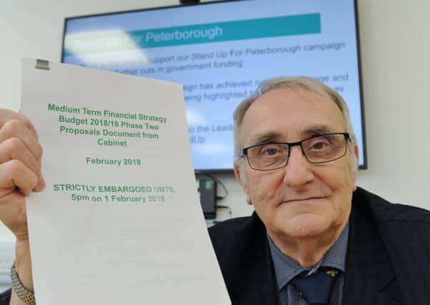 Peterborough City Council leader Cllr John Holdich with a copy of the budget