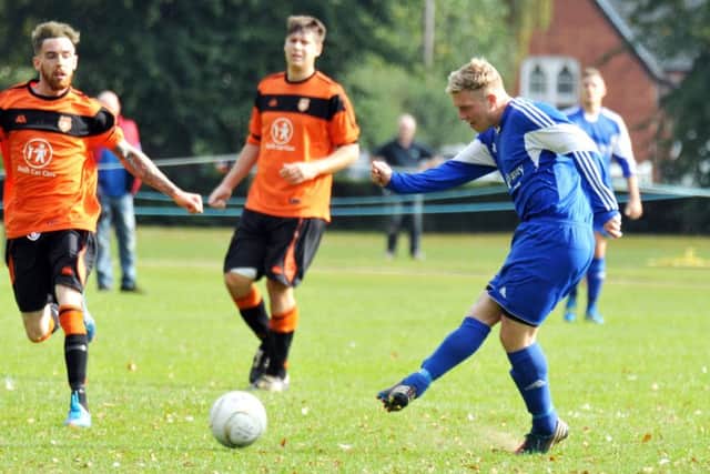 Joe Townsend (blue) scored twice for Moulton Harrox in a Lincs Junior Cup semi-final.