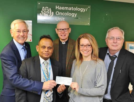 Peter Thompson, Revd David Rideway and Jo Morris from St Kyneburgha Church, Castor and Peterborough Telegraph photographer David Lowndes present  a cheque to Dr. Siva Kumaran at the Haematology Unit at the City Hospital  after an evening talk at the church EMN-180302-175245009