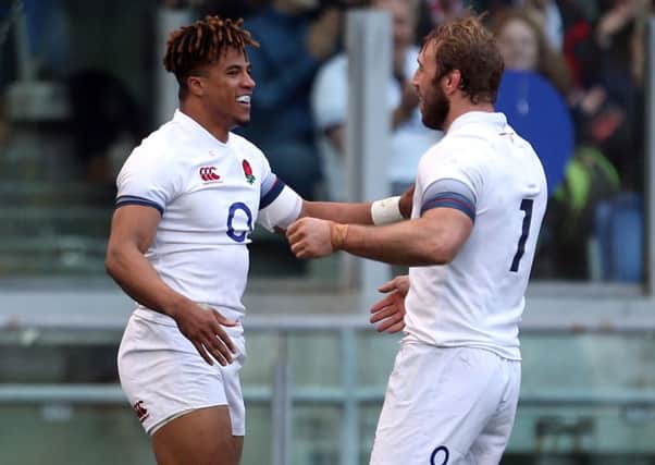 England's Anthony Watson (left) celebrates a try in Italy.