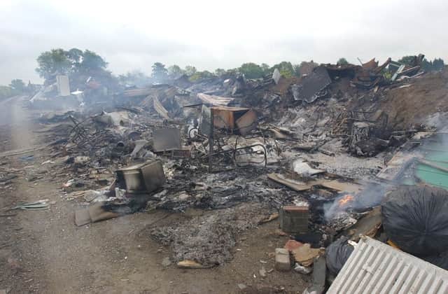 Paston gipsy site fire. city council staff begin a monthly clearance along Norwood lane of rubbish, etc, dumped by travellers. NB fire from last night still burns in background. ENGEMN00120110206145849