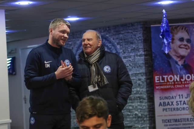 Peterborough United manager Grant McCann and Tommy Robson speak to sponsors before the game.