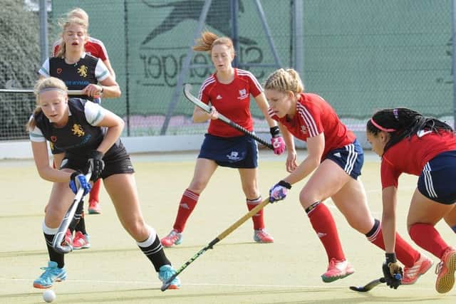 Anna Faux (red, centre) was player-of-the-match for City of Peterborough Ladies against Wapping.