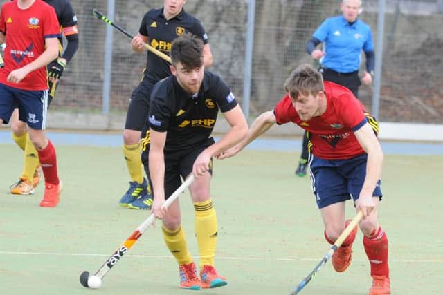 City of Peterborough's Ben Read (red) battles for possession against Beeston, . Photo: David Lowndes.