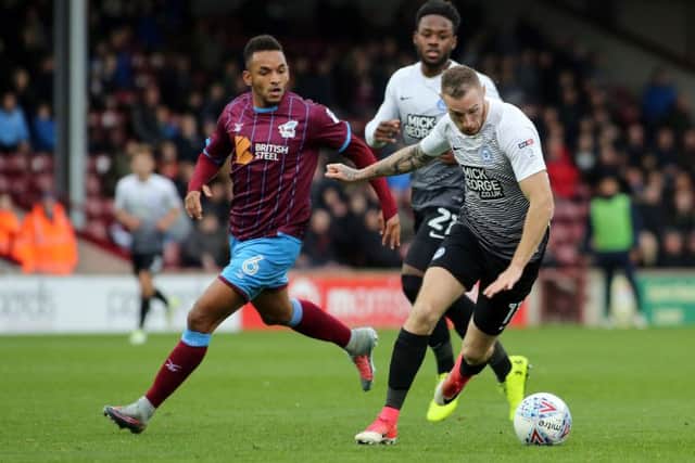 Marcus Maddison in action for Posh against Scunthorpe earlier this season.