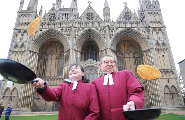 Pancake Day at Peterborough Cathedral. Revd Canon Sarah Brown the Residentiary Canon at Peterborough Cathedral and The Very Revd. Christopher Dalliston, Dean of Peterborough Cathedral. EMN-180213-123708009
