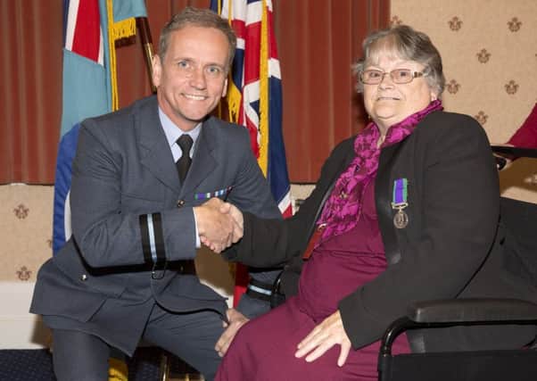 Ann receives her medal from Air Commodore Mark Gilligan