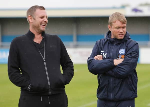 Posh chairman Darragh MacAnthony (left) with manager Grant McCann.