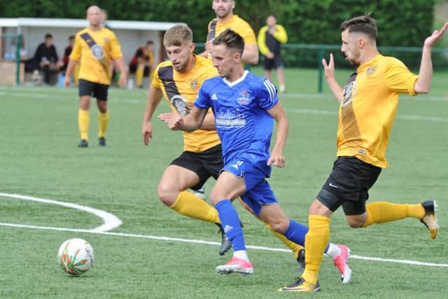 Matt Sparrow (blue) scored for Yaxley at Deeping.