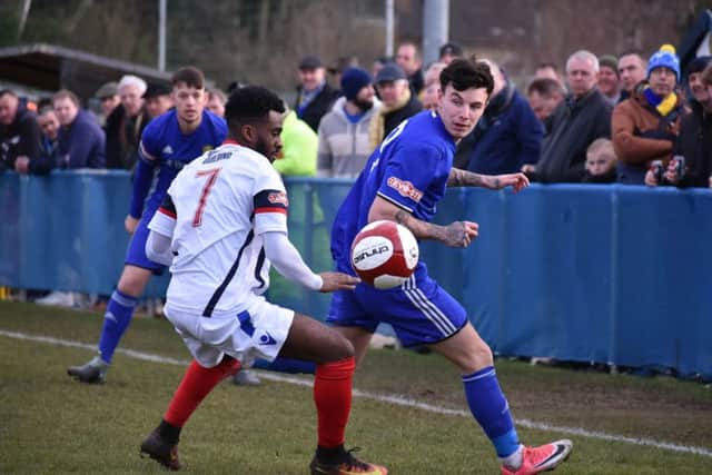 James Macleod (blue) in action for Peterborough Sports against Newcastle Town. Photo: James Richardson.