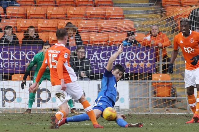 Posh skipper Jack Baldwin launches into a tackle at Blackpool. Photo: Joe Dent/theposh.com.