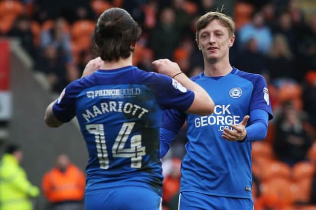 Posh midfielder Chris Forrester congratulates Jack Marriott on his goal at Blackpool. Photo: Joe Dent/theposh.com.
