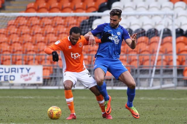 Ryan Tafazolli of Peterborough United closes down Nathan Delfouneso of Blackpool. Photo: Joe Dent/theposh.com.