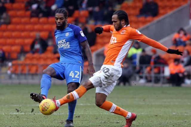 Posh midfielder Anthony Grant takes on Blackpool goalscorer Nathan Delfouneso. Photo: Joe Dent/theposh.com.