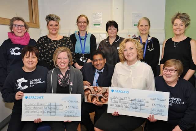 Ladies from Gratefully Uncovered, cancer sufferers who raised funds from a calender, presenting cheques to staff at Cancer Research UK and NW Anglia Breast Unit CF at the City Hospital EMN-180215-151436009