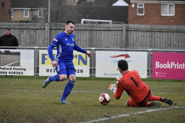 Peterborough Sports' forward Josh Moreman races in on the Newcastle goalkeeper. Photo: James Richardson.